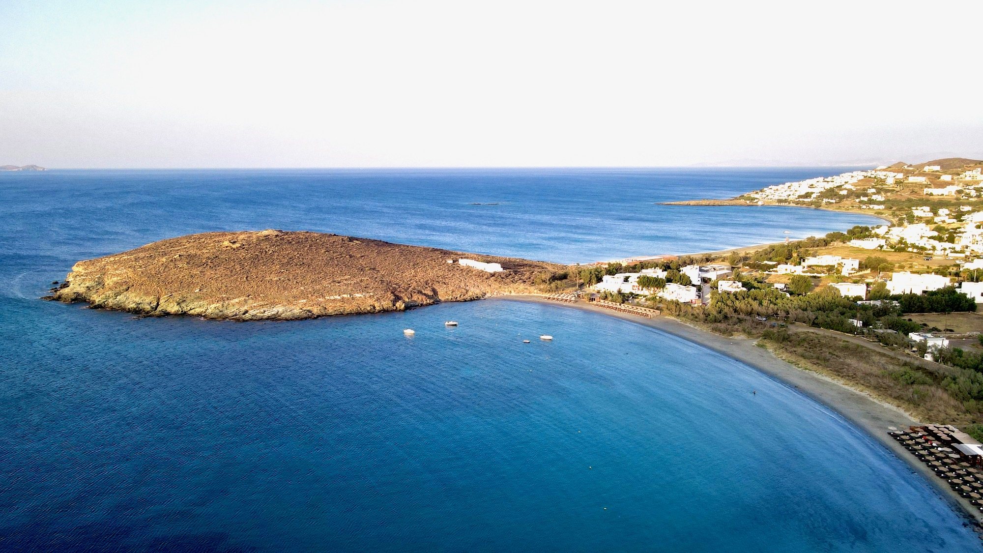 Aerial view of Agios Ioannis bay, its headland and curved beach