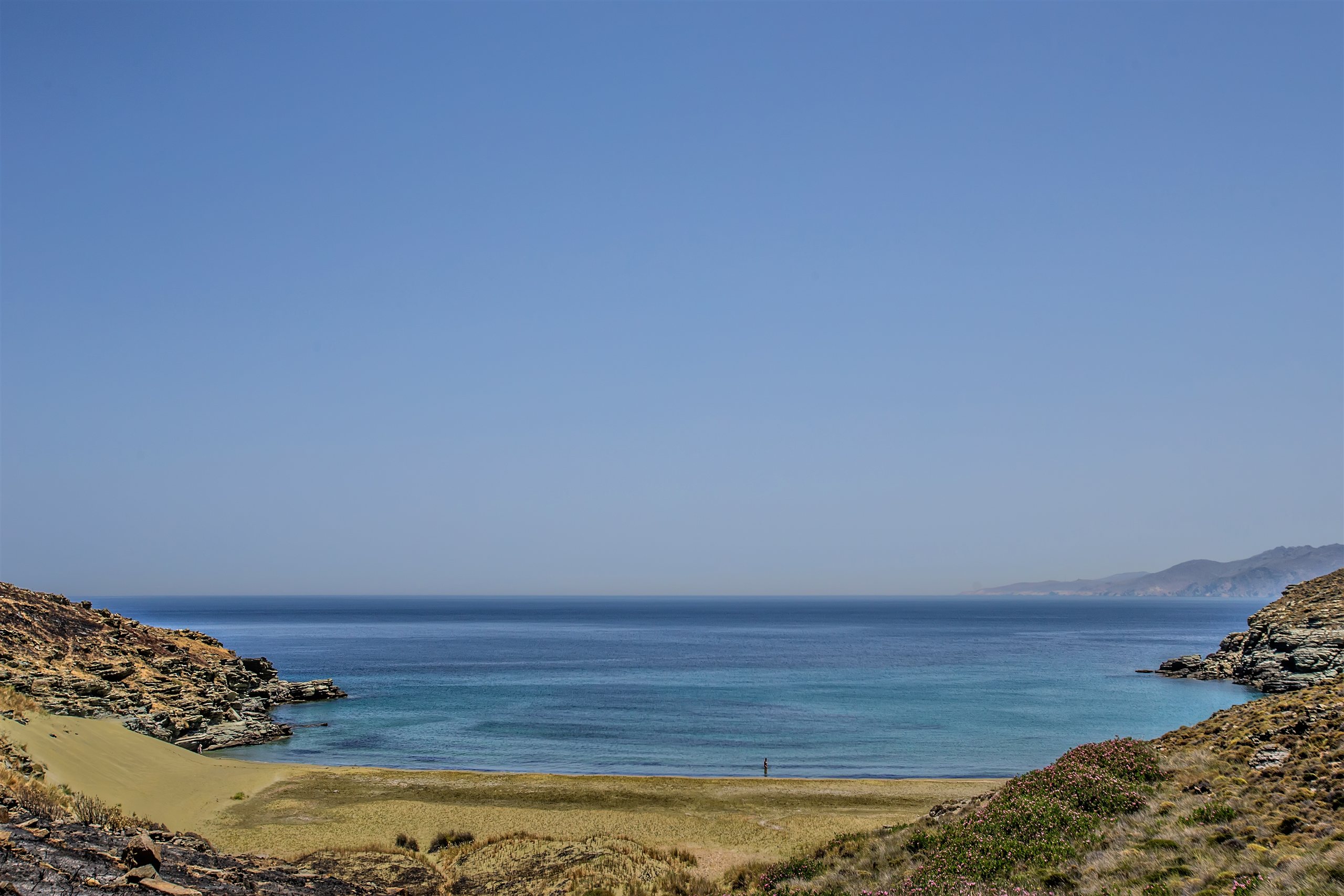 The quiet sandy cove of Pachia Ammos framed by rocky headlands